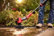 Photo of a Craftsman CMCPSHB power scrubber cleaning a wet patio surface outdoors, held by a person in jeans and boots.